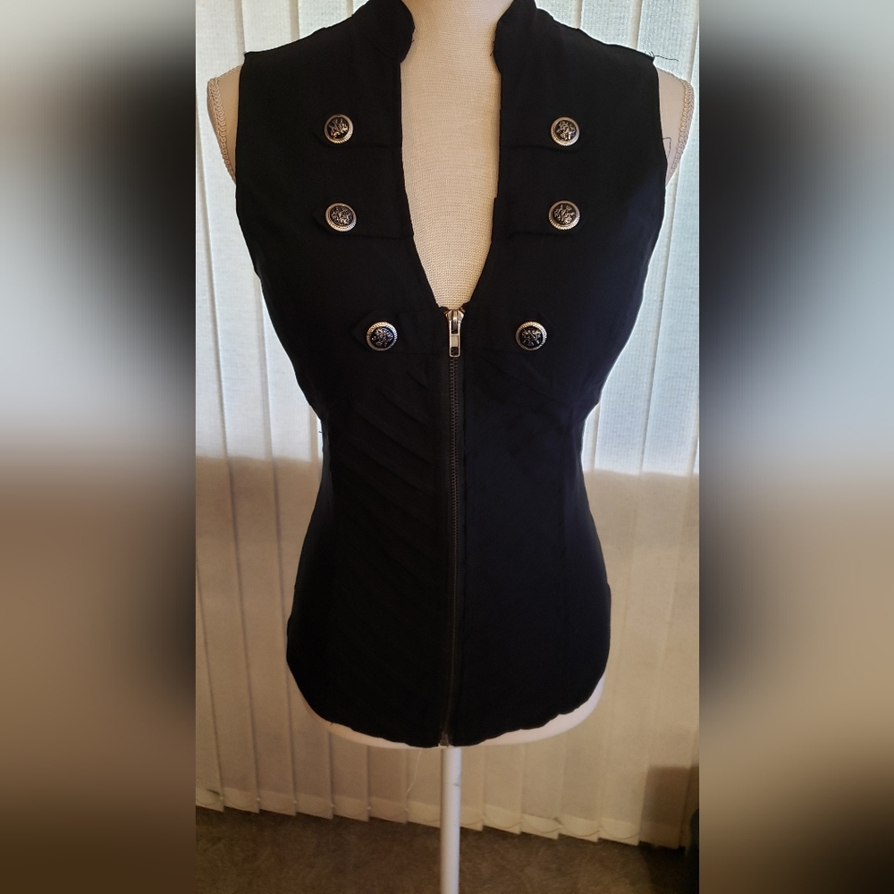 Black vest with button accents. Criss cross design on back also. Size 1x